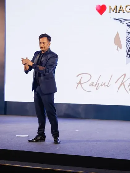 Performing my digital magic routine at the Panasonic event. The large screen behind me displays my branding, reinforcing my identity as an illusionist, mentalist, and magic designer.