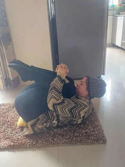 A student in a reclined pose during a private session. We tailor each class to the client's needs, focusing on gentle, restorative poses when needed.