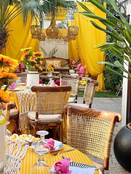 A view of the sunflower-themed dining area, showing how the decor extends from the seating lounge to the guest tables for a cohesive event design.