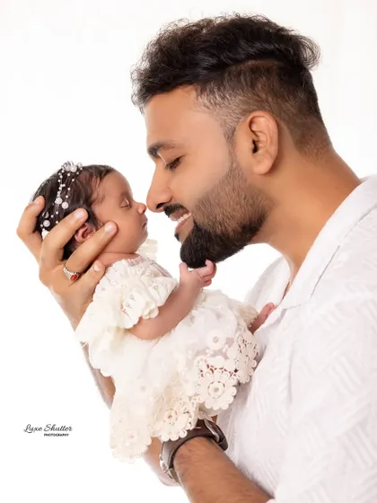 A beautiful moment between a father and his newborn daughter, their noses touching. This captures the gentle and loving side of fatherhood.