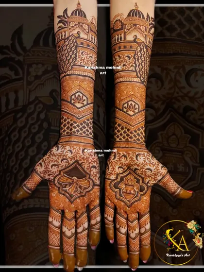This design captures the grandeur of a royal wedding with its focus on architectural and traditional motifs. It features majestic palace domes and peacocks on the forearms, flowing down into intricate patterns on the palms for a truly regal bridal look.