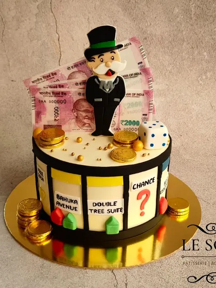 A fun Monopoly-themed cake for a board game lover. This 1 kg cake is decorated with edible money, fondant game pieces, and the iconic Monopoly man.