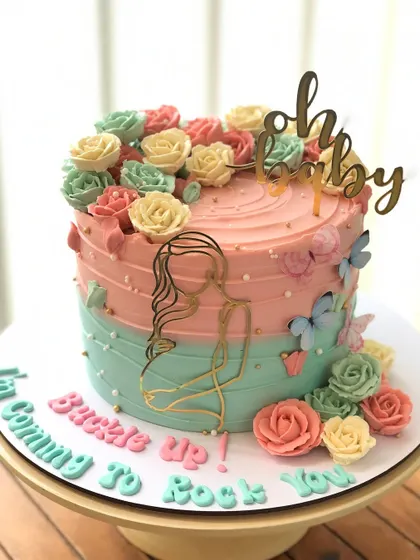 A "Buckle Up, I'm Coming to Rock Your World" baby shower cake, with a modern line-art topper and colorful buttercream flowers.