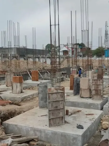 Concrete columns rising from the foundation at the Jammu & Kashmir site. This behind-the-scenes view shows the structural skeleton that will support the final elegant design.