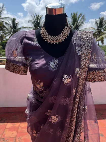 The puff sleeves with embroidered borders are a trendy detail on this ready-to-wear saree.