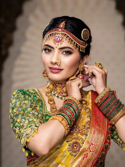 This detailed photoshoot showcases a complete South Indian bridal look, from the intricate matha patti and layered necklaces to the flawless airbrush makeup and traditional saree draping.