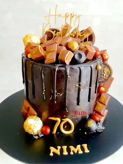 An absolutely decadent chocolate overload cake for a 70th birthday. This rich chocolate drip cake is loaded with various chocolates like Ferrero Rocher and Dairy Milk, making it a dream come true for any chocolate lover.