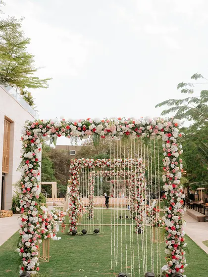 Imagine walking towards your forever through a dreamy pathway of floral arches. We design immersive entrances like this one to make your journey to the mandap feel truly spectacular.