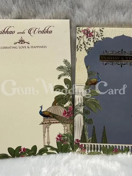 A stunning new design for the season, this hardback card features a beautiful Pichwai-inspired theme with peacocks and lush foliage against a deep blue archway.