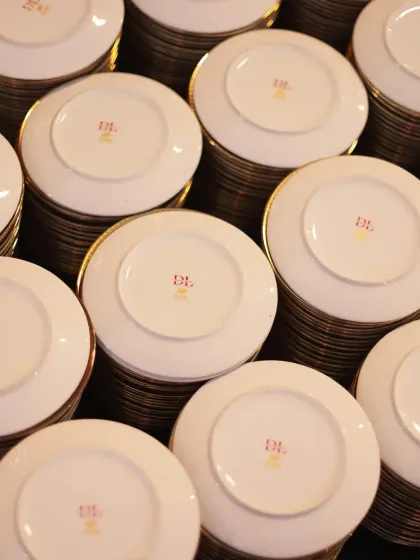 An army of plates, stacked and waiting. This image represents our readiness and capability to handle events of any scale without compromising on quality or presentation.