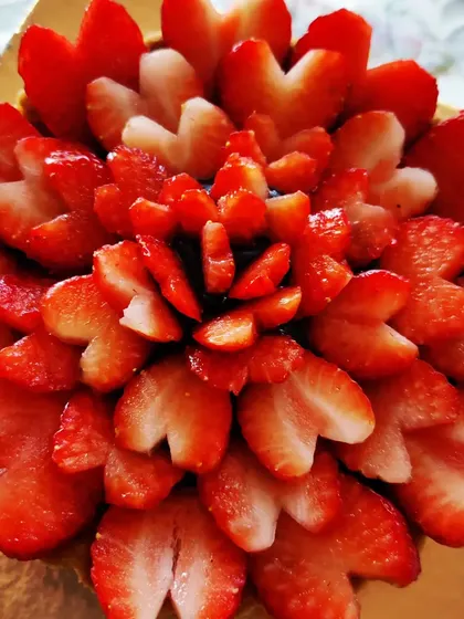 A stunning Chocolate Strawberry Tart, beautifully decorated with fresh strawberries cut into heart shapes, making it a perfect dessert for Valentine's Day.