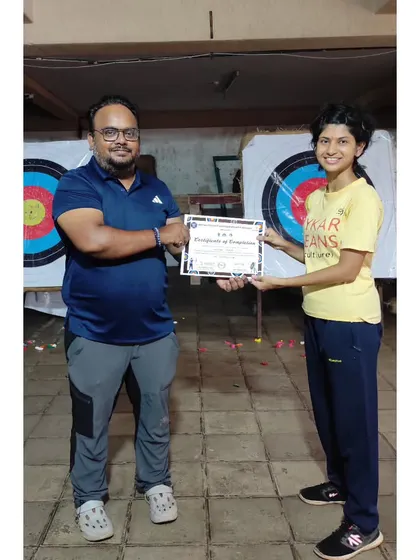 An adult student proudly displays her certificate. It's never too late to learn a new skill.