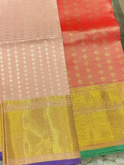 Soft pastel Kanjeevaram blouse pieces in peach and coral tones. These are perfect for creating an elegant, understated look for daytime events.