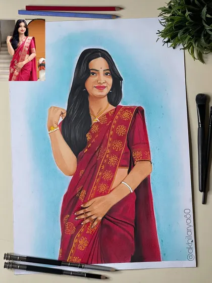 This A3 colored pencil portrait of a woman in a red saree has a lovely blue background that makes the subject pop. It's a great example of using color to create mood.