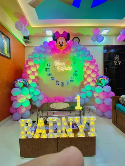 The same Minnie Mouse setup with green lighting, showing the versatility of the decor with simple light changes.