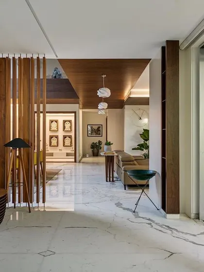 The transition from the interior living space to the outdoor deck in Kanasu, designed with large sliding doors that blur the line between inside and out.