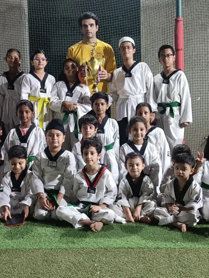 Our team of young warriors with their coach and a well-earned trophy. This is the face of dedication.