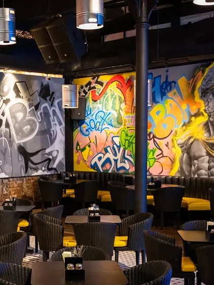 A full view of a commercial mural for Lil Gamby in Parel. We mixed Greek god imagery with modern portraits and graffiti lettering to create a unique vibe for the space.