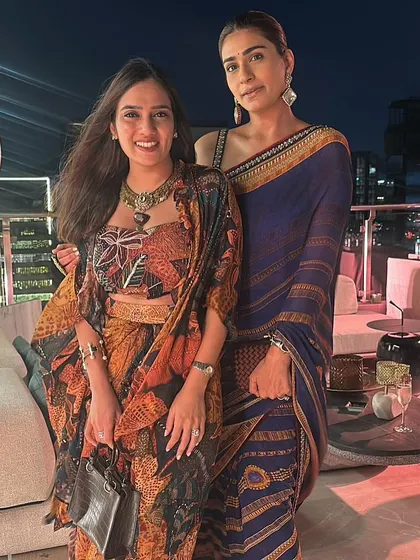 Posing with a friend in a navy blue Tarun Tahiliani printed saree. It's an elegant and understated choice for an evening event.