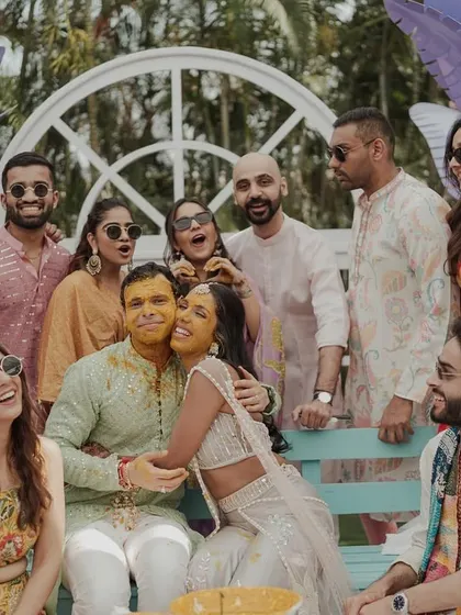 A beautiful group photo of the couple with their friends and family during the Haldi ceremony. A memory of love and togetherness.