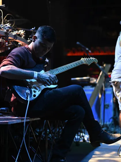 Another look at my guitarist's focused intensity during a live show. The dedication to his craft is inspiring.