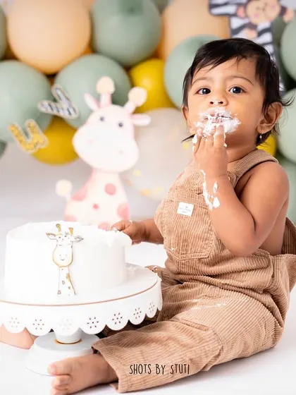 Fully committed to the task at hand. I love capturing the focus and determination of a baby exploring their first birthday cake. It's a sweet and funny memory for the whole family.