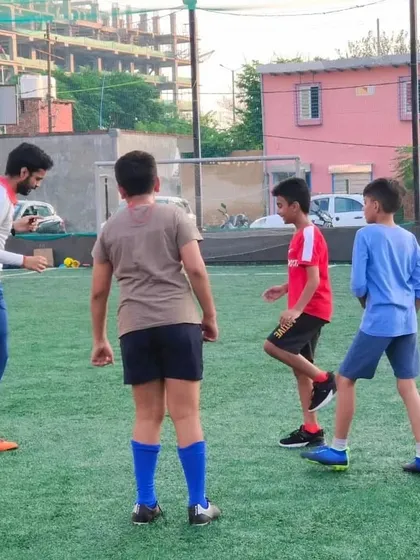 A coach provides individual instruction to players during a free camp session. We make sure every child gets personal attention to help them learn and improve.