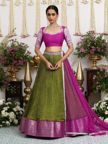 A beautiful magenta Bandhani lehenga with a matching embroidered blouse and silver gota detailing.