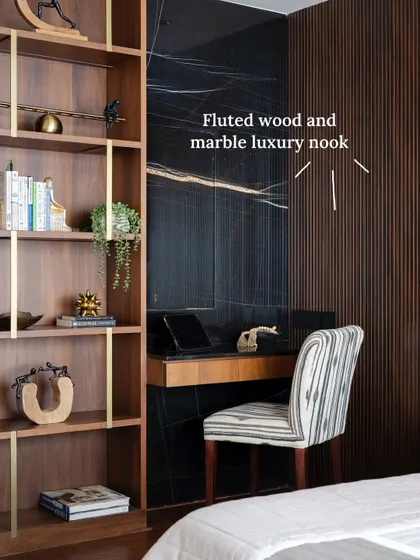 A bold black Marquinho marble backdrop instantly elevates this tucked-in workspace, paired with warm wood textures that echo the larger master suite’s palette.