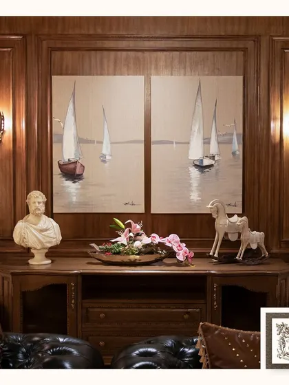 This pair of vintage sailboat seascape paintings brings a sense of adventure and tranquility to this classic, wood-paneled room. They are perfect for creating a sophisticated, nautical-themed space.