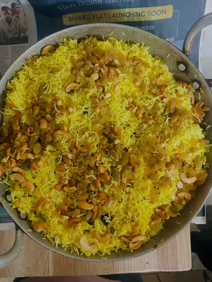 Our fragrant Lemon Rice, tempered with mustard seeds, curry leaves, and garnished with cashews and raisins for a delightful crunch.
