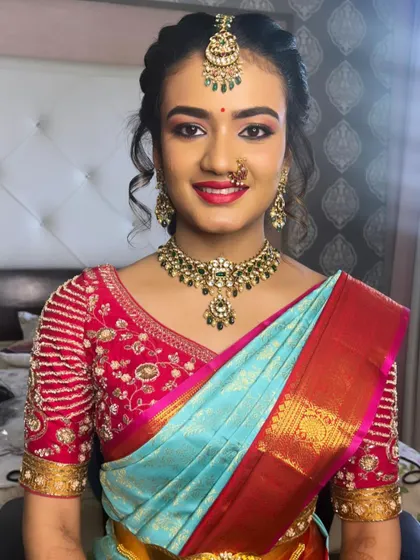 A classic South Indian traditional makeup look for a family wedding. I paired a warm, shimmering eye with a complementary pink lip shade to perfectly match her beautiful silk saree and temple jewelry.