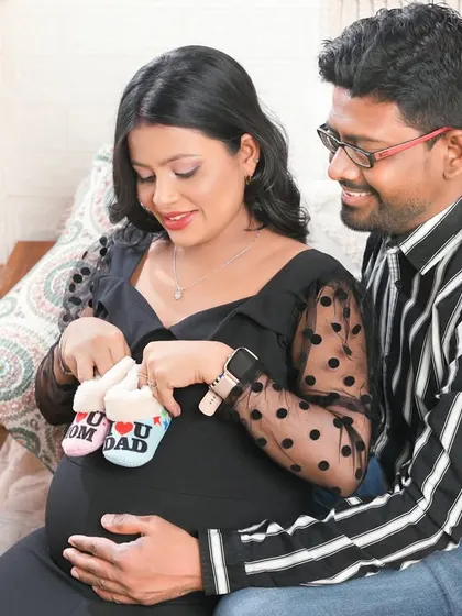 Another beautiful moment with the "I love Mom/Dad" booties. This pose highlights the shared joy and anticipation of the parents-to-be.