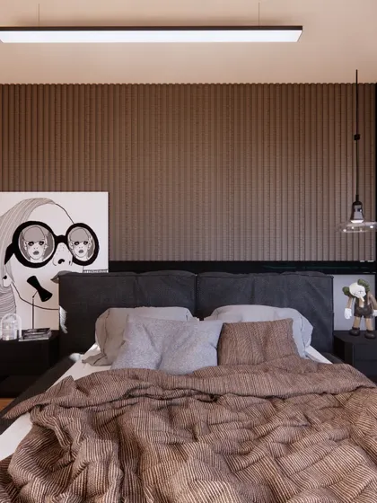 The bed in the gaming room is set against a dark, fluted wall panel, creating a moody and textured backdrop.