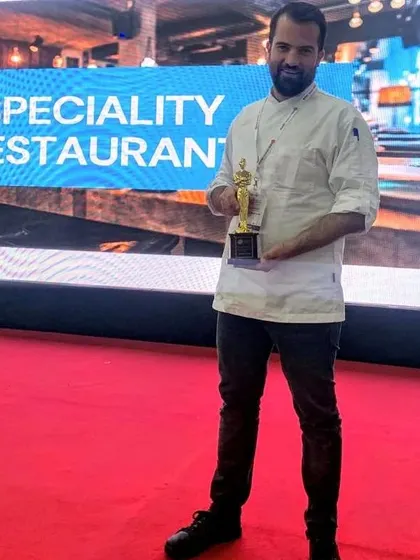 Another shot of me with the award for Speciality Restaurant. This recognition is a testament to my team's hard work and dedication.