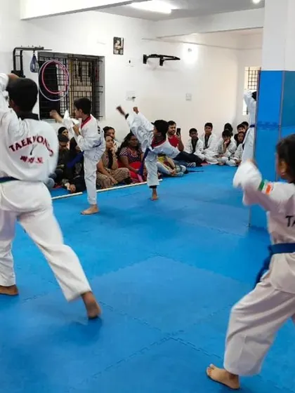 A view from the back of students practicing their kicks.