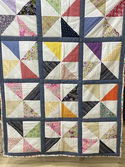 A simple but classic quilt made of "half-square triangle" blocks, using a variety of colorful scrap fabrics.