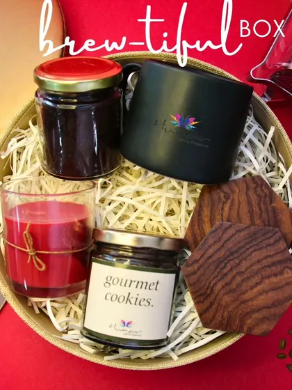 Our 'Brew-tiful Box' is a dream for any coffee lover. This pre-curated hamper includes locally sourced coffee, a custom mug, gourmet cookies, and a scented candle for the perfect coffee break.