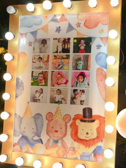 A personalized milestone board for Vihaan, showcasing his photos from each month of his first year. We framed it with marquee lights to match the carnival theme.