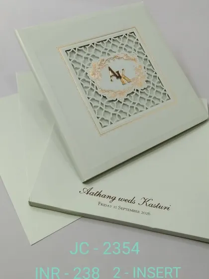 This sage green invitation features a laser-cut lattice window with a custom monogram. The design is clean, modern, and elegant.