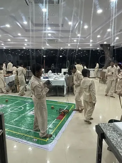 A view of one of our well-equipped labs where students are engaged in various robotics and coding activities, including a soccer-bot field setup.