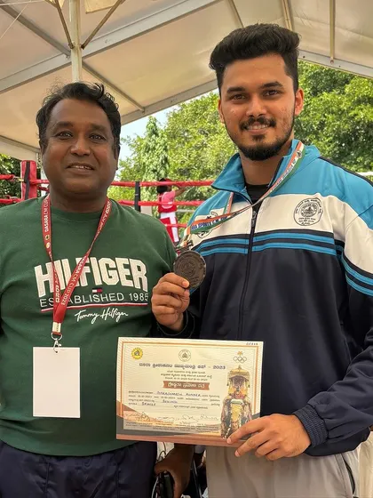 Receiving congratulations and my medal at the Dasara Games. These events are crucial for athlete development.