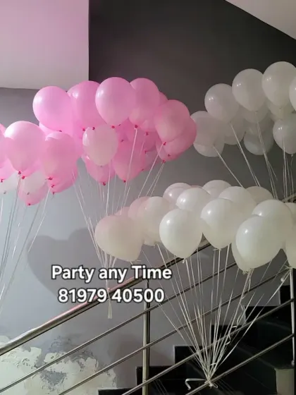 Bunches of pink and white helium balloons ready for delivery.
