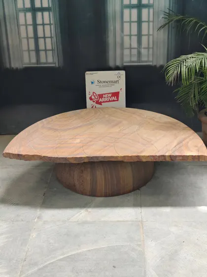 This modern stone seating bench features a smooth, curved top and a solid, rounded base. It's a contemporary design that works equally well in a luxury interior or an extraordinary backyard garden.