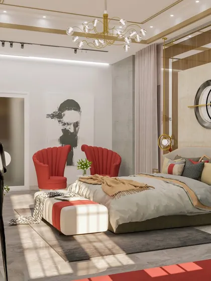 The 'Golden Glam' bedroom is the epitome of luxury, with plush red armchairs, a large comfortable bed, and statement decor pieces.
