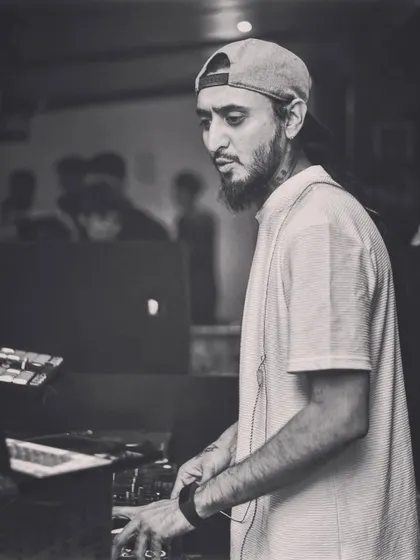 A candid black and white photo of me at work, focused on the mixer. These are the quiet moments of concentration amidst the noise.