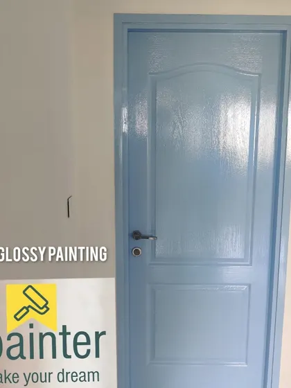 The same light blue glossy door, showing the smooth, reflective surface that is characteristic of a professional high-gloss paint job.