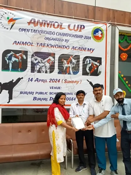 Presenting an award during the Anmol Cup ceremony. It is an honor to recognize the hard work and dedication of the participants and supporters.