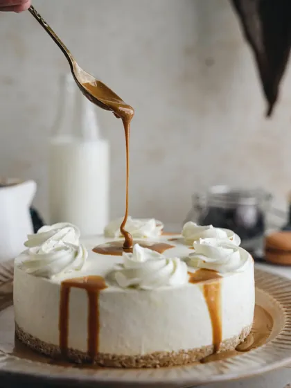 A study in beige. This monochromatic scene with a caramel cheesecake creates a soft, elegant, and sophisticated mood, highlighting the smooth texture of the cake and the luscious caramel drip.