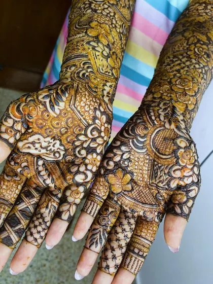 A close-up of the palms, showcasing the intricate and detailed patterns of the bridal henna.